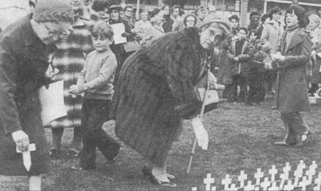 Saidie Patterson plants a memorial Peace Cross for her great-nephewin Belfast in 1979. Photograph from the Bleakley Collection.