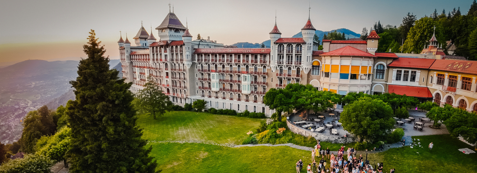 Caux Palace HATCH people in garden drone 2023 banner